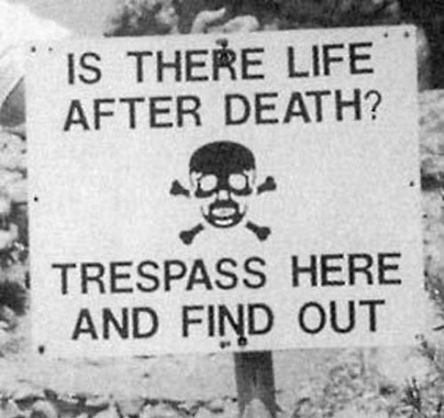 Sign Reading "Is There Life After Death? Trespass Here and Find Out."