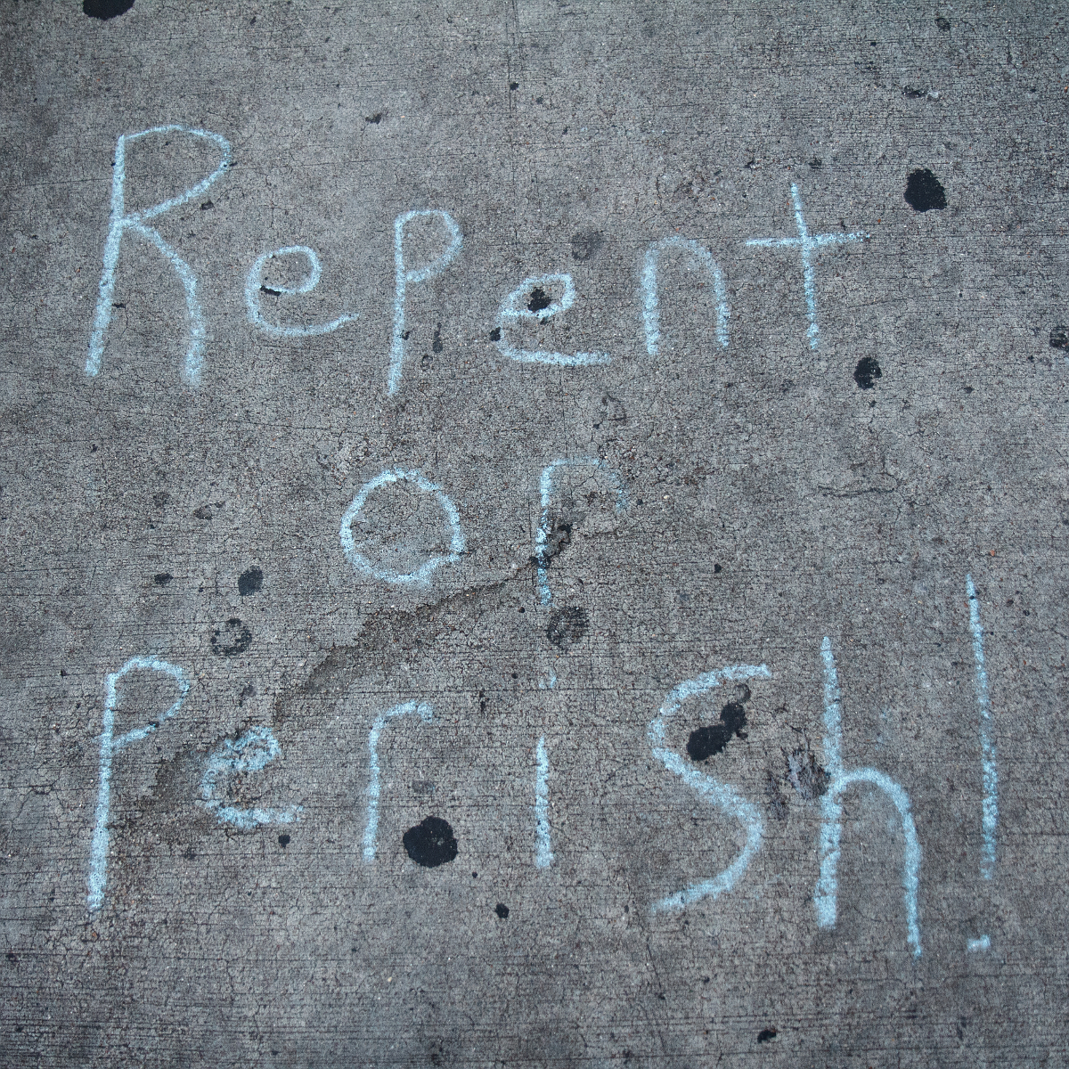 blue repent-or-perish text on stone