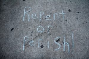 blue repent-or-perish text on stone